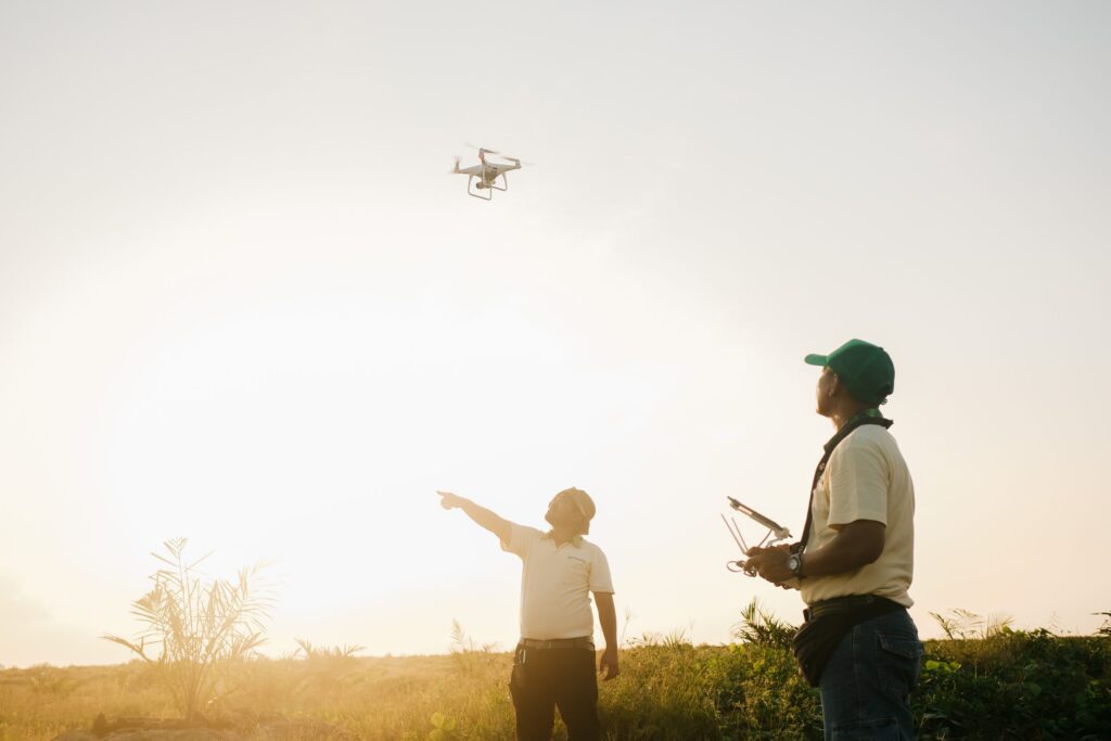 Musim Mas GIS staff looking at his handheld device to control the drone and assess the hotspot.