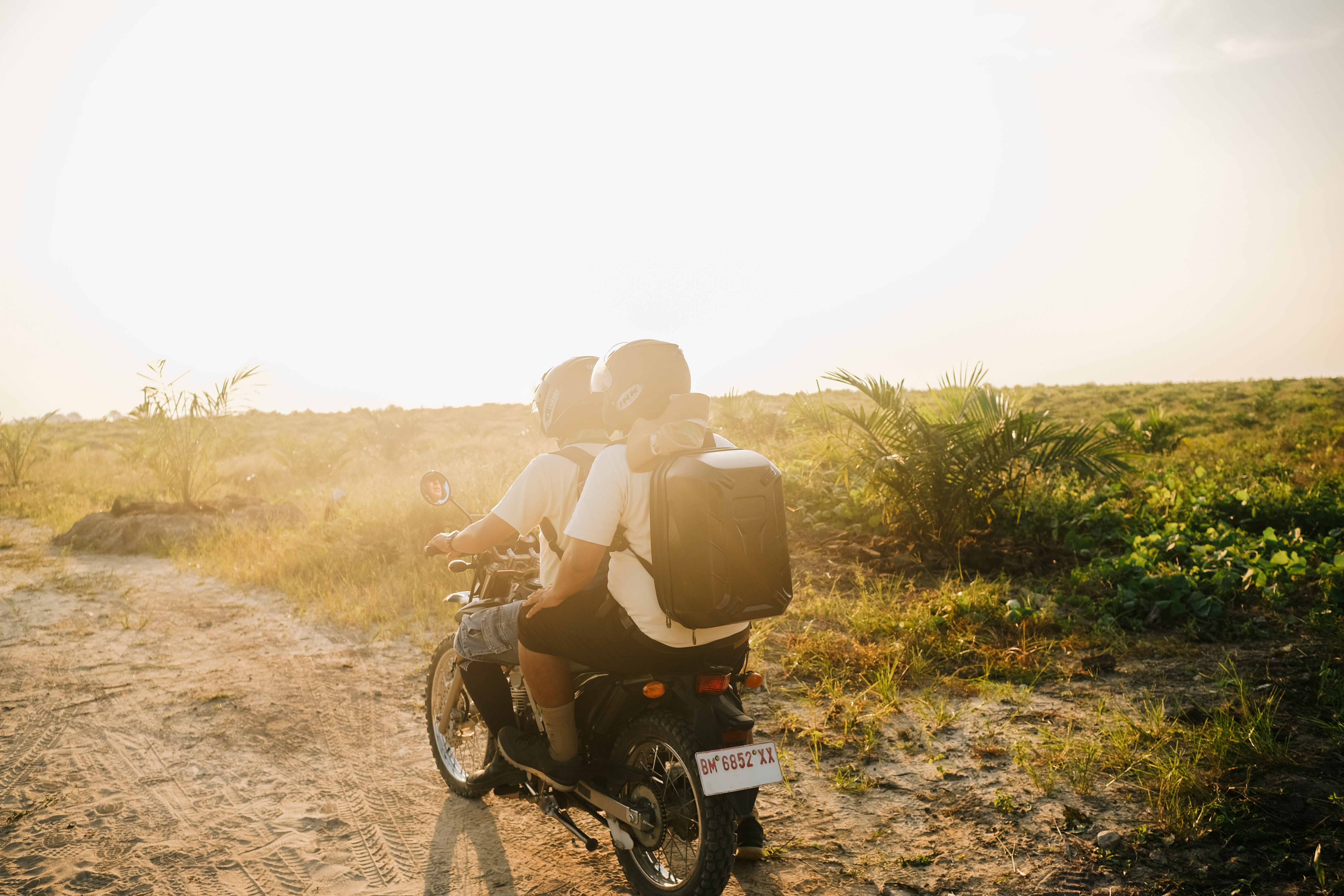 Musim Mas GIS team riding a motorcycle in the plantation to investigate potential hotspot.